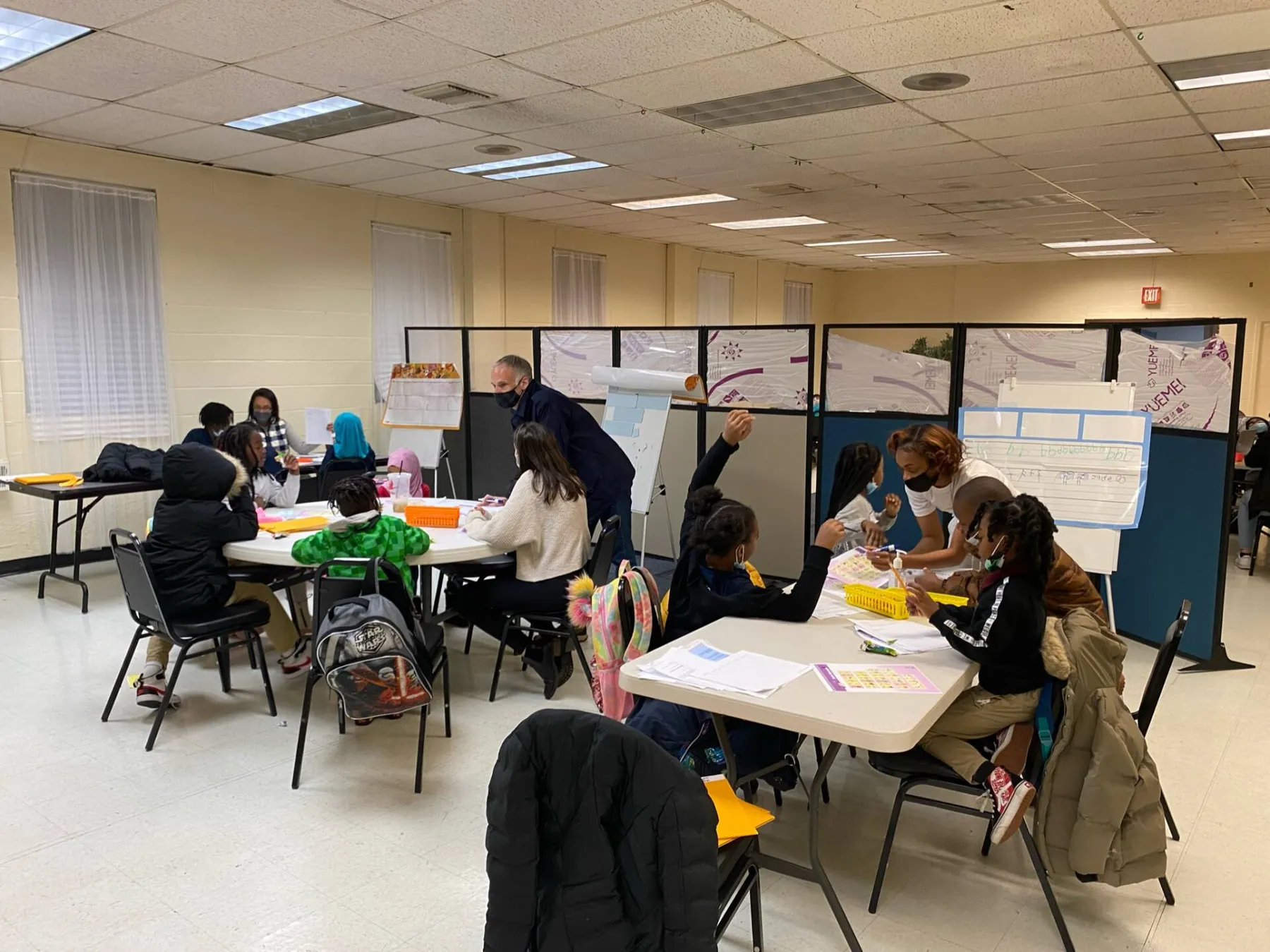 Students working at widely spaced tables in a classroom
