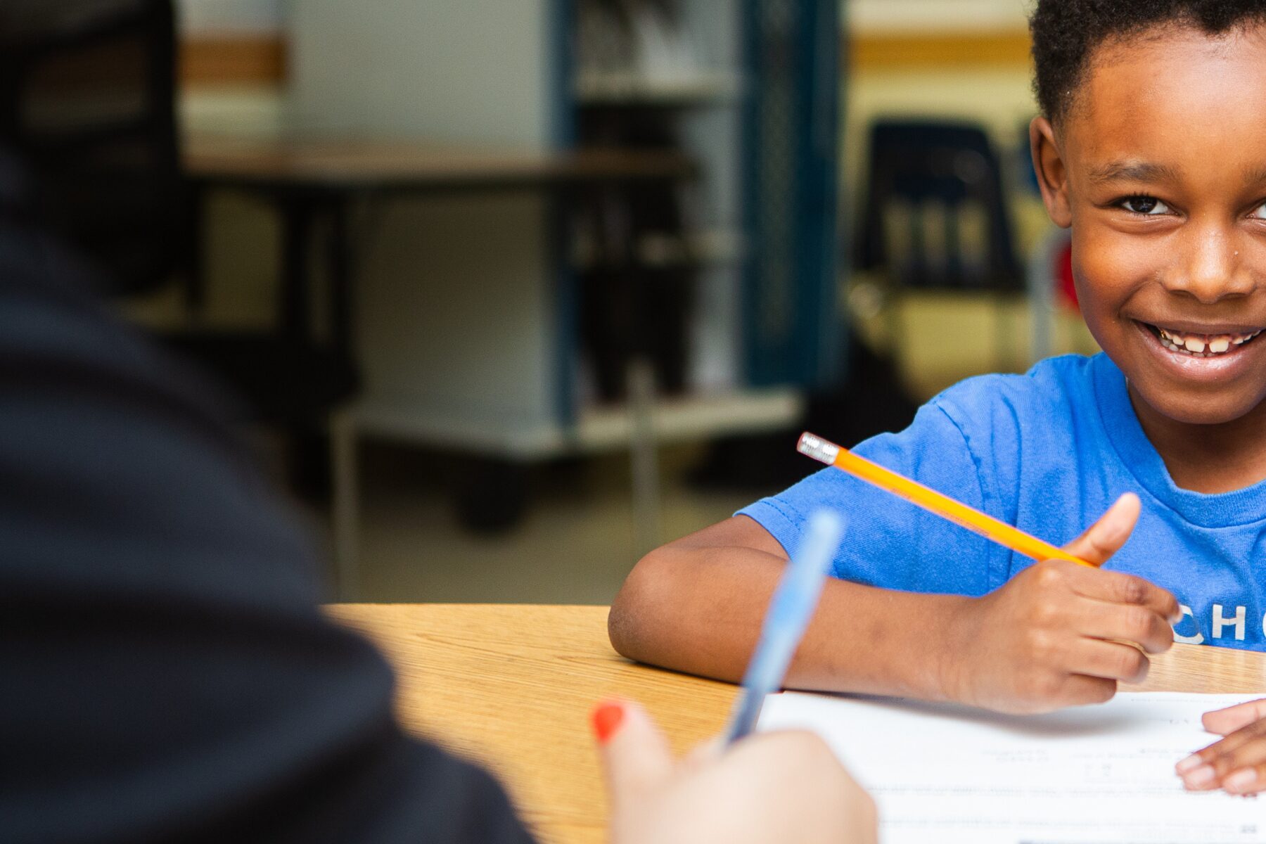 Happy student smiles during high-impact tutoring to accelerate learning