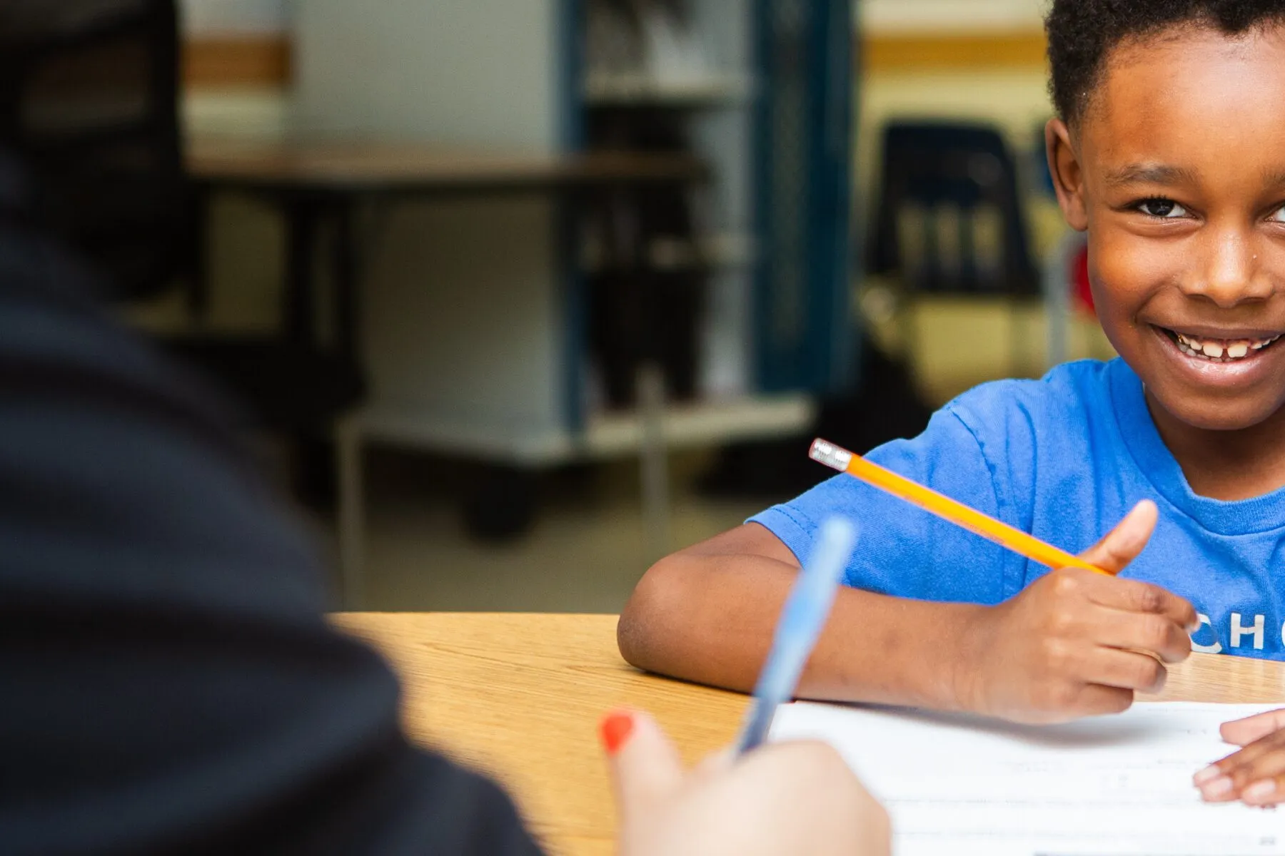 Happy student smiles during high-impact tutoring to accelerate learning