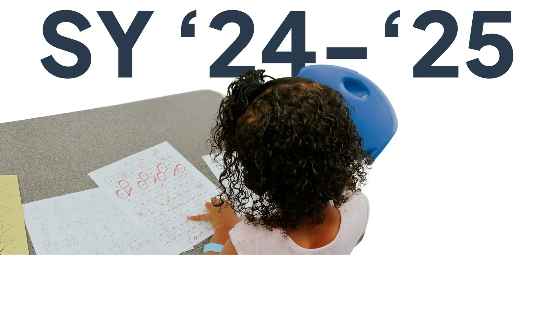School year 2024–25 graphic showing a child drawing at a table