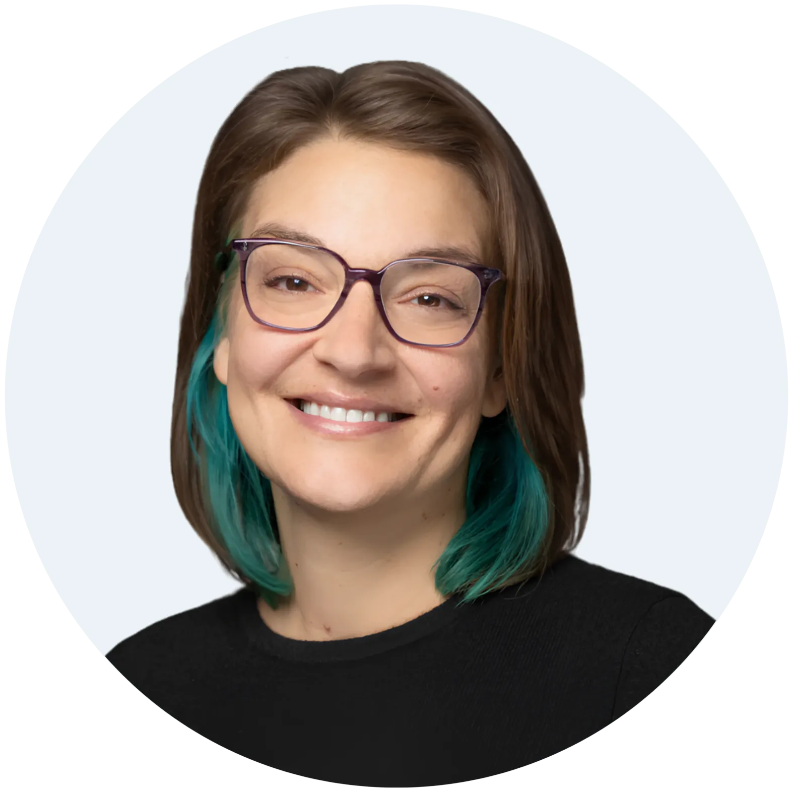 Circular portrait of a smiling woman with glasses and teal-tipped hair - CitySchools Collaborative Circular portrait of a smiling woman with glasses and teal-tipped hair